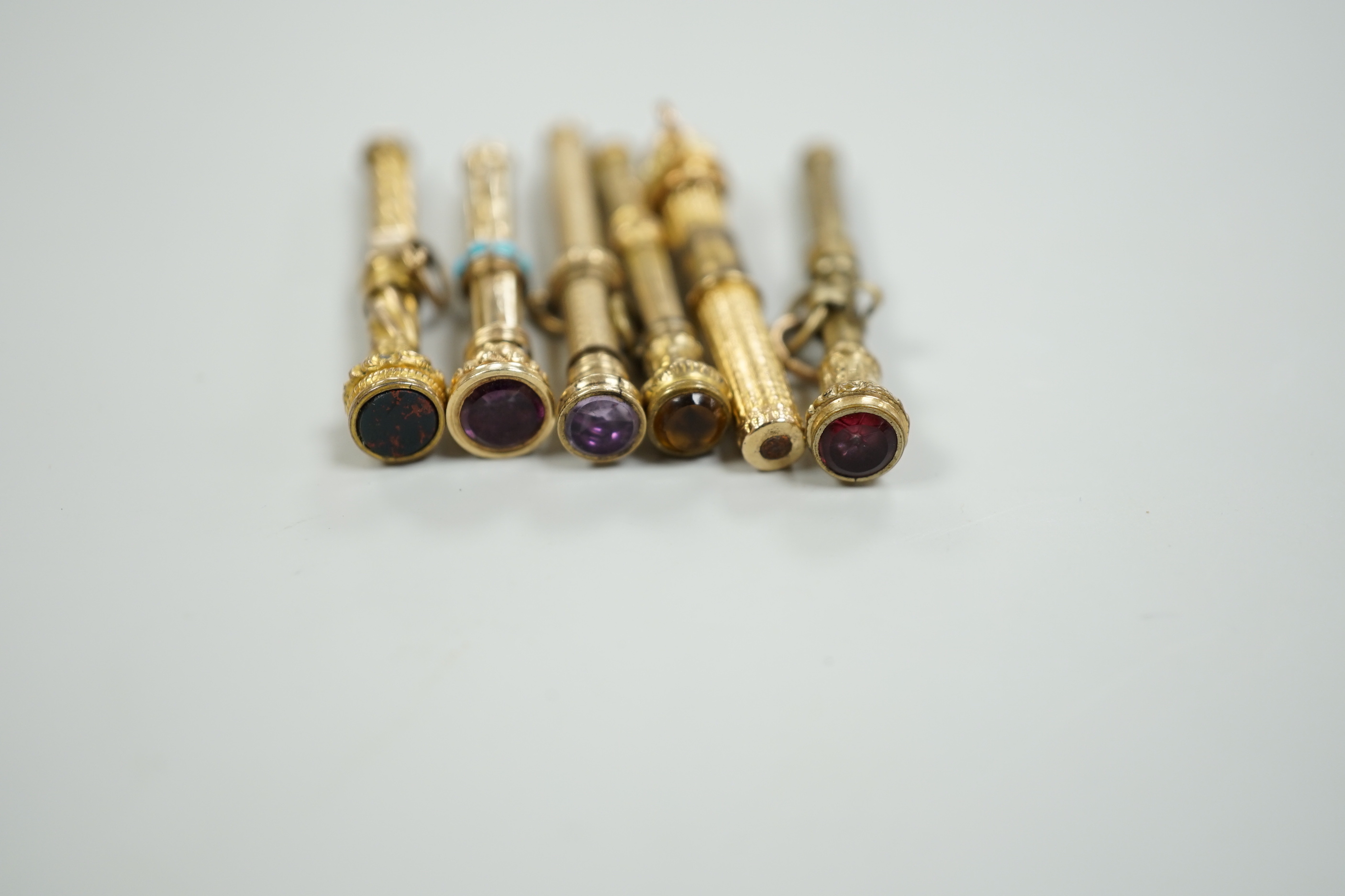 Six assorted late 19th/early 20th century yellow metal overlaid propelling pencils, including turquoise set, 38mm and bloodstone set.